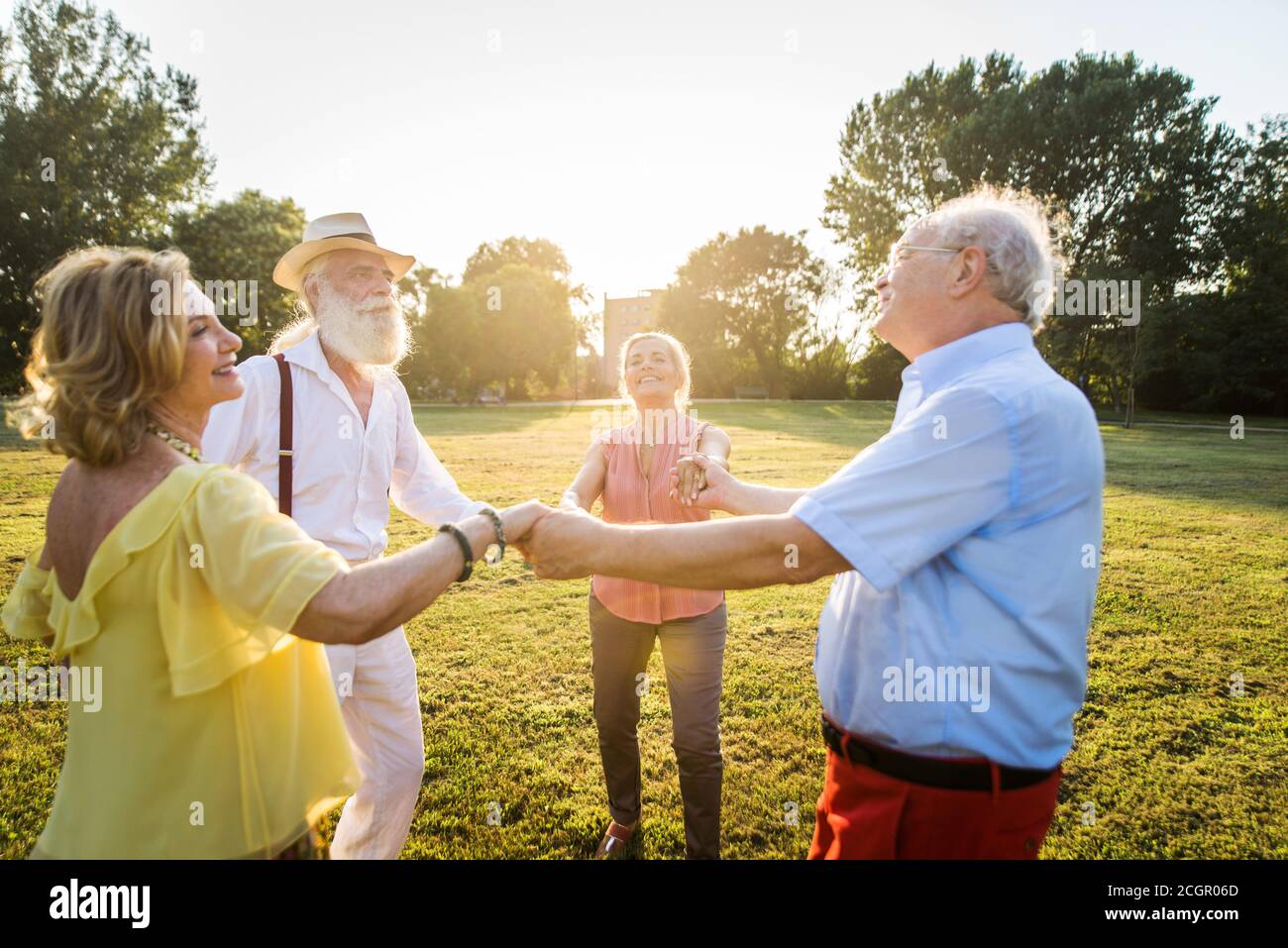 Group of youthful seniors having fun outdoors - Four pensioners bonding outdoors, concepts about lifestyle and elderly Stock Photo