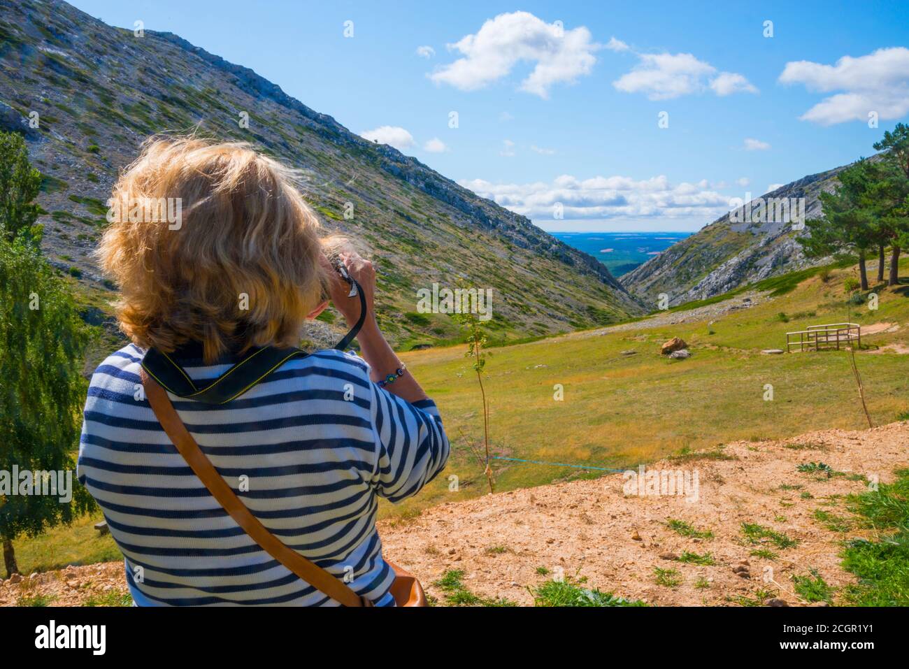 Mature woman taking photos of the landscape. El Brezo sanctuary, Villafria de la Peña, Palencia province, Castilla Leon, Spain. Stock Photo
