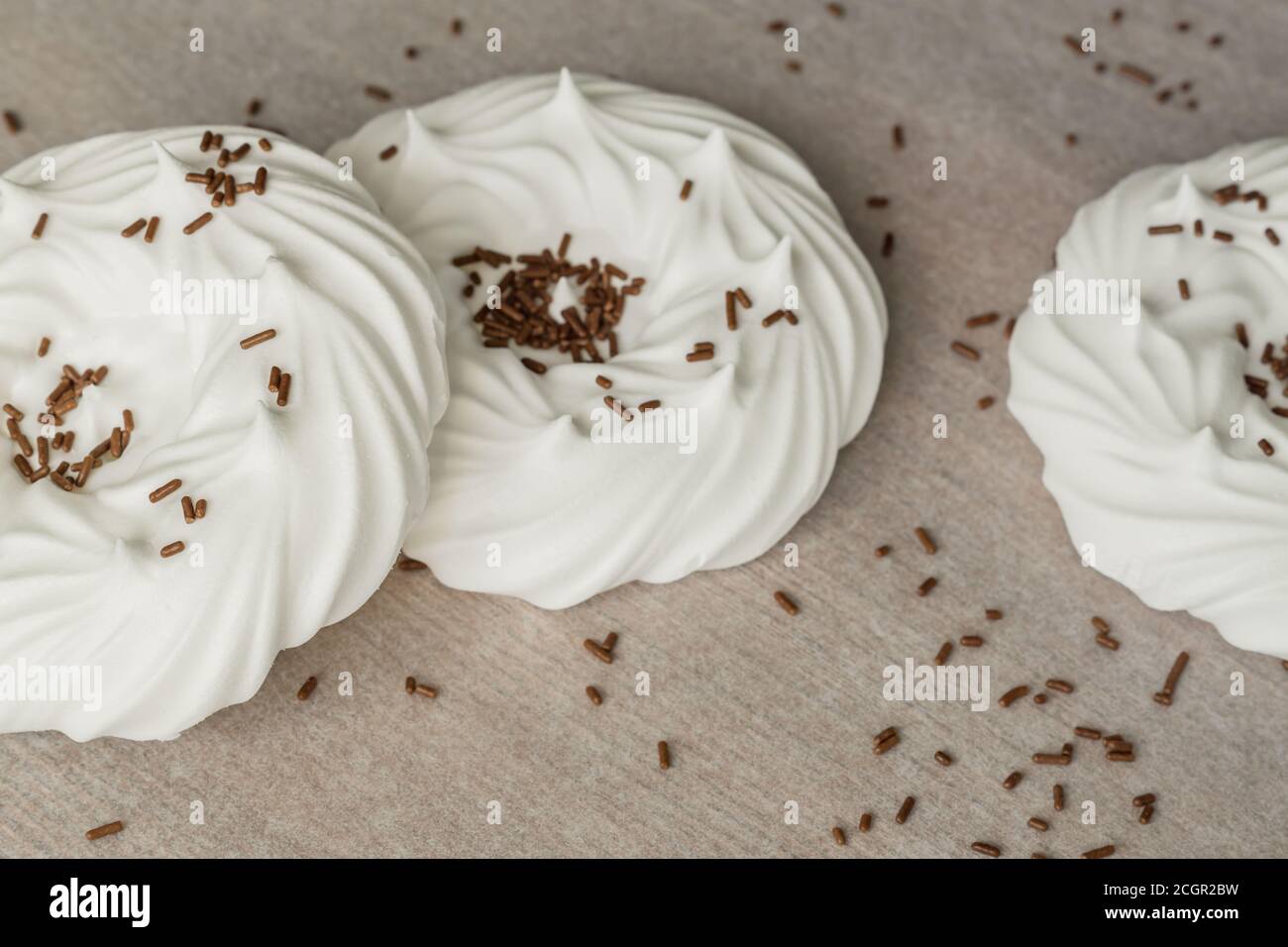 homemade white air meringues and chocolate confectionery decorations on