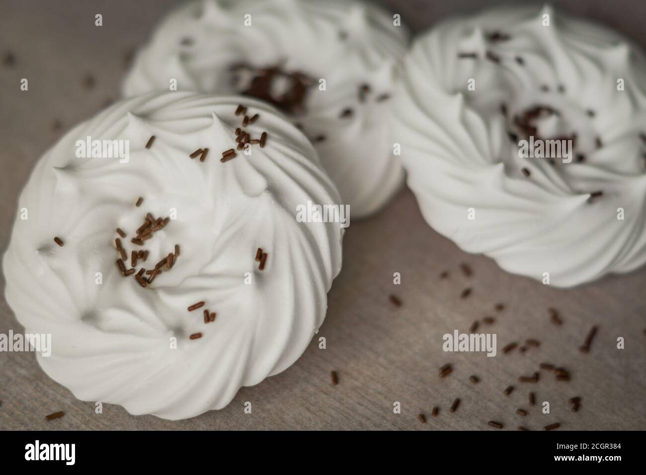 homemade white air meringues and chocolate confectionery decorations on