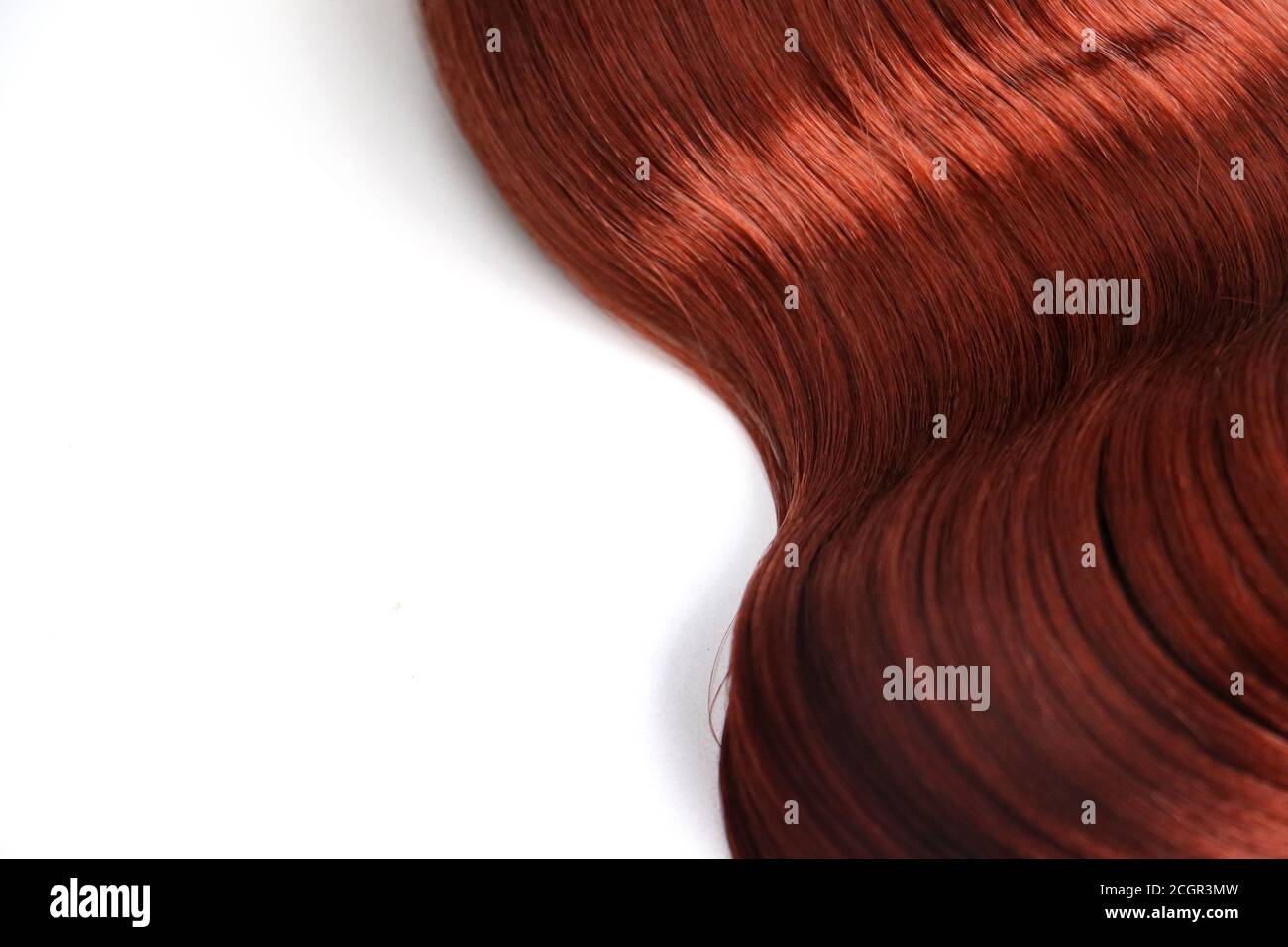 red auburn wavy hair piece isolated on white background Stock Photo