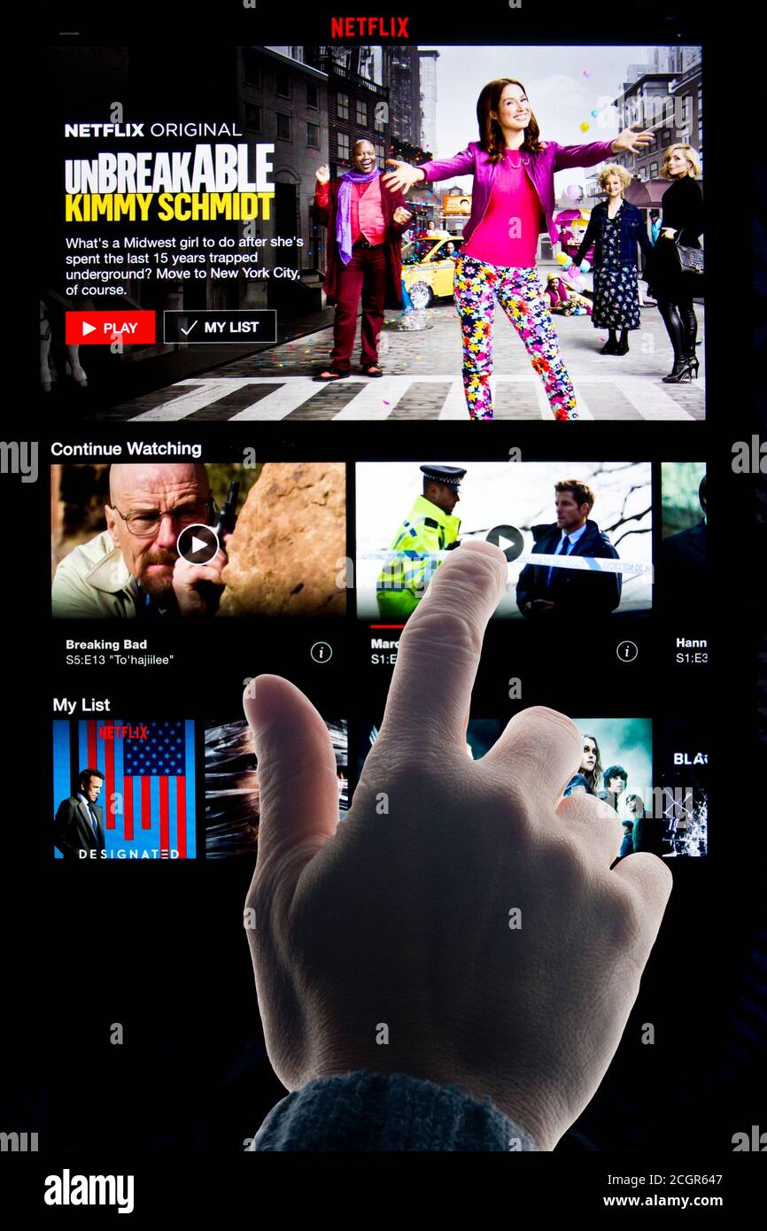 hand on touch screen tablet choosing a program on Netflix Stock Photo