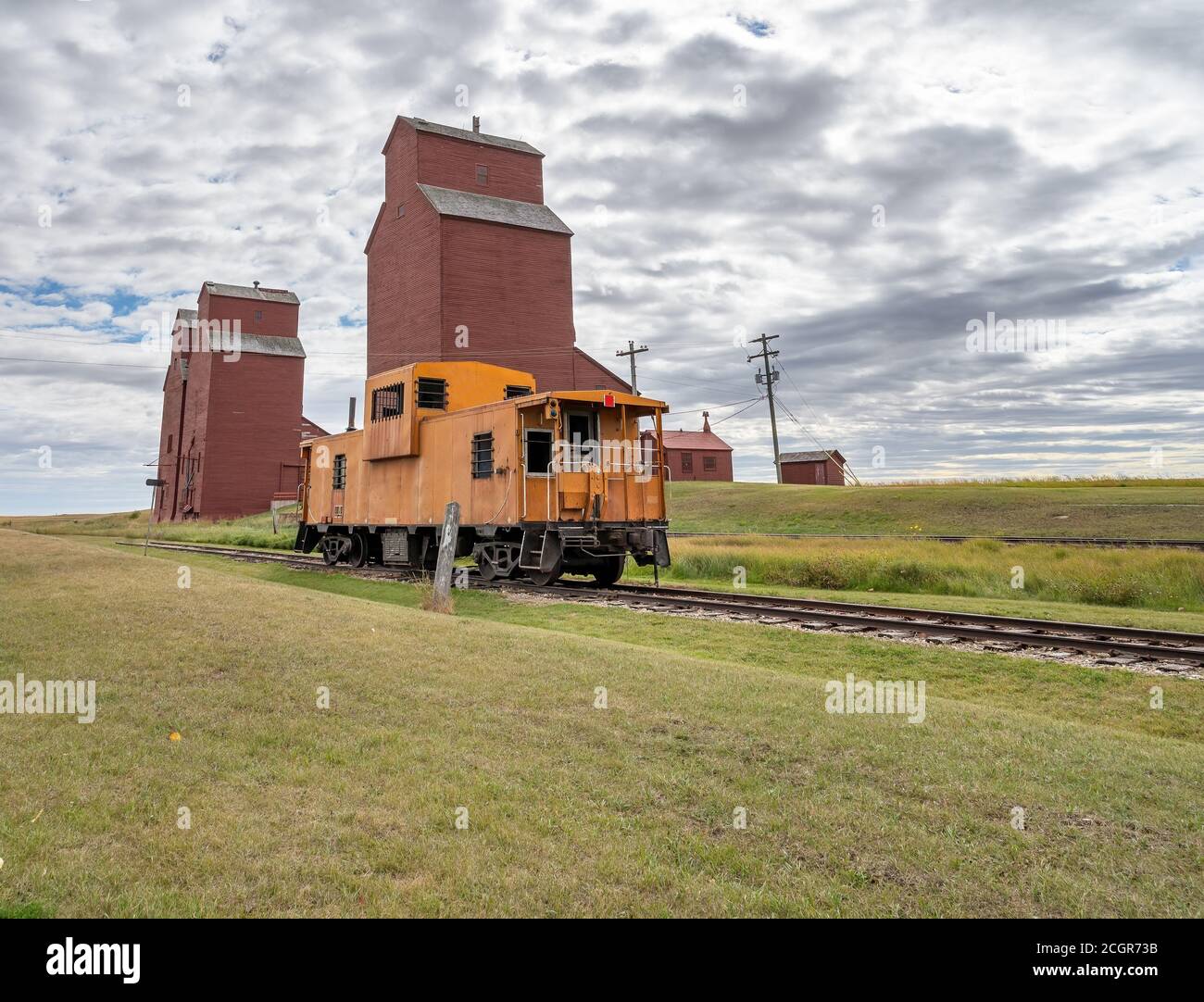 Grain elevators and train caboose in rural Alberta, Canada Stock Photo