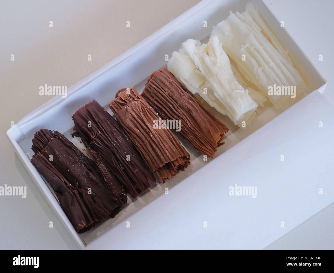 chocolate rolls. chocolate firewood. homemade dark, white and milk chocolate sticks Stock Photo