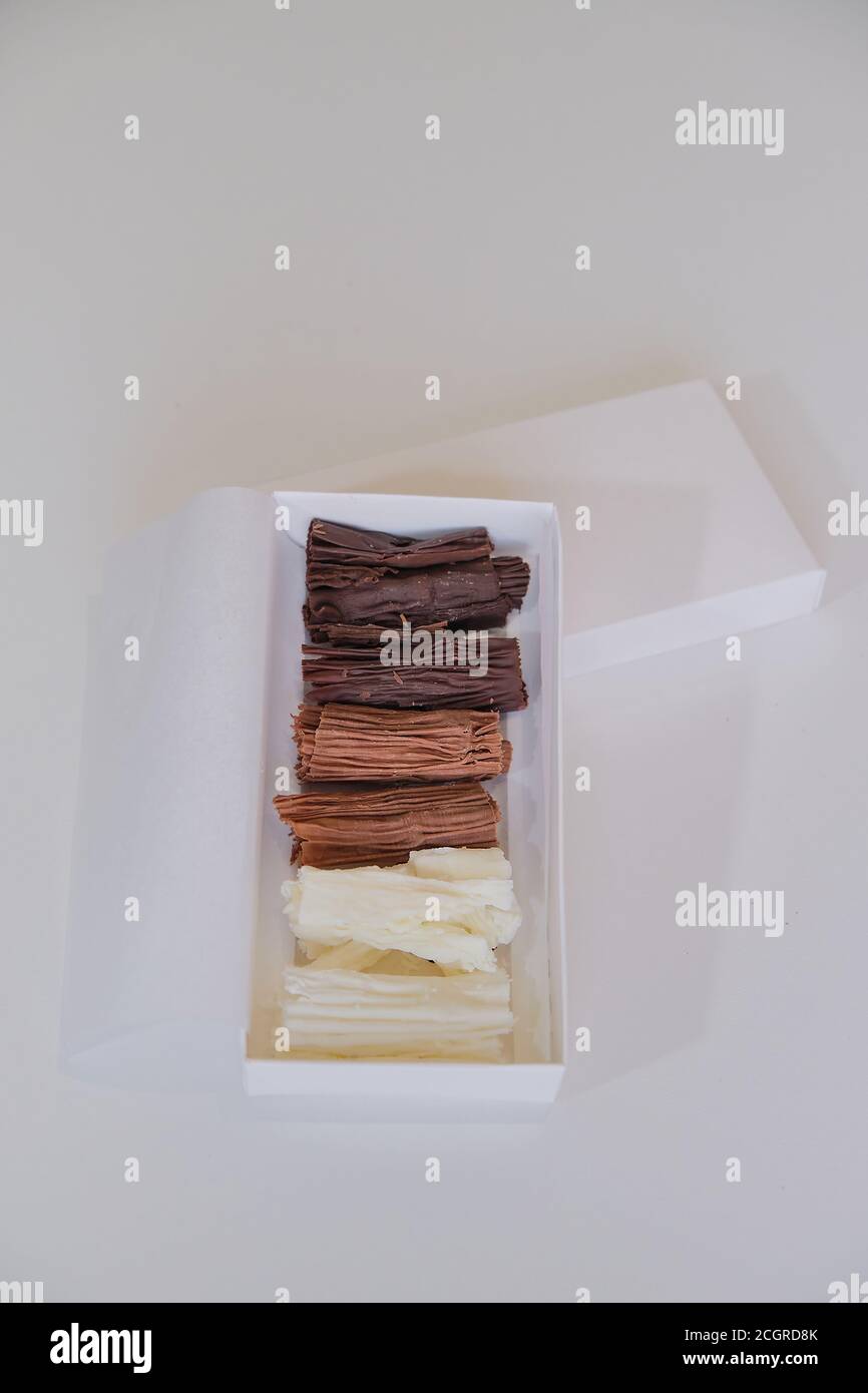 chocolate rolls. chocolate firewood. homemade dark, white and milk chocolate sticks Stock Photo