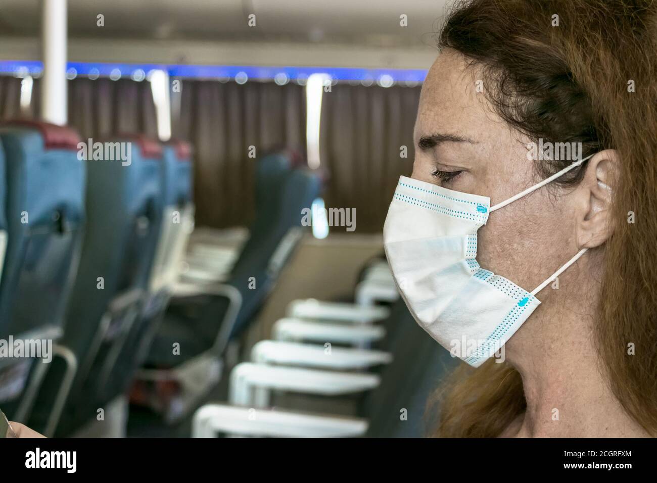 Close-up of a woman on ferry ship with a surgical mask during Covid-19 travelling in Greece Stock Photo