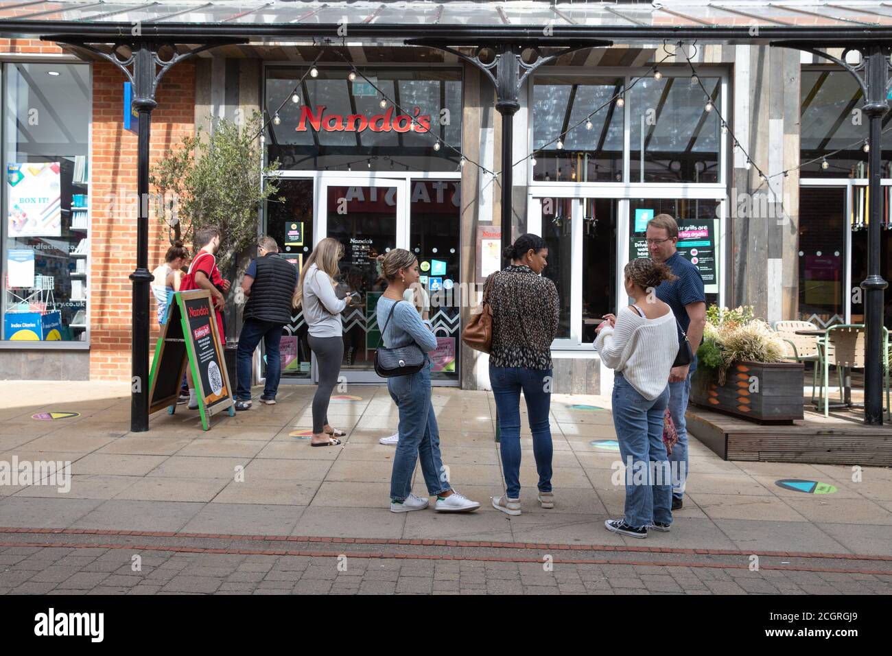 Sevenoaks,Kent,12th September 2020,People queue outside Nando's restaurant in Sevenoaks, Kent. The forecast is for 21C sunny intervals with a gentle breeze and is to continue with high temperatures for the next few days.Credit: Keith Larby/Alamy Live News Stock Photo
