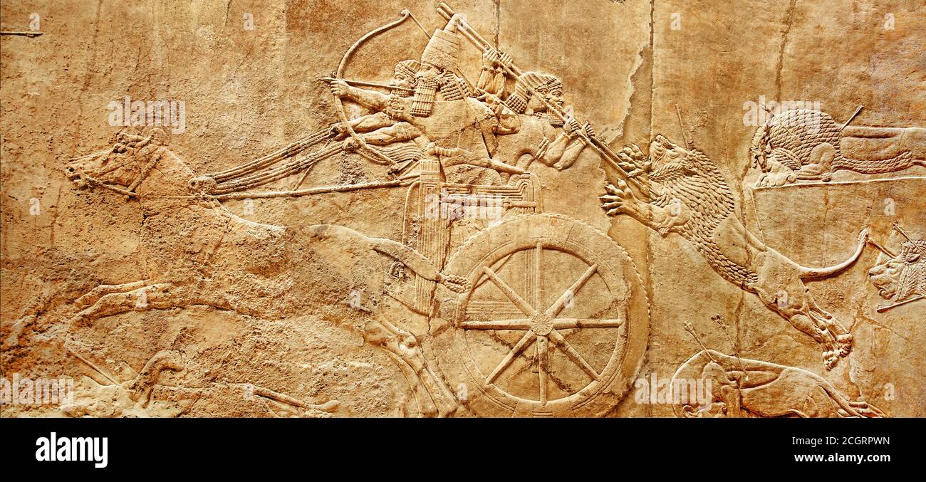Assyrian wall relief of lion hunt, king Ashurbanipal with warriors on carving from Middle East and Mesopotamia. History of past civilization of Iran a Stock Photo