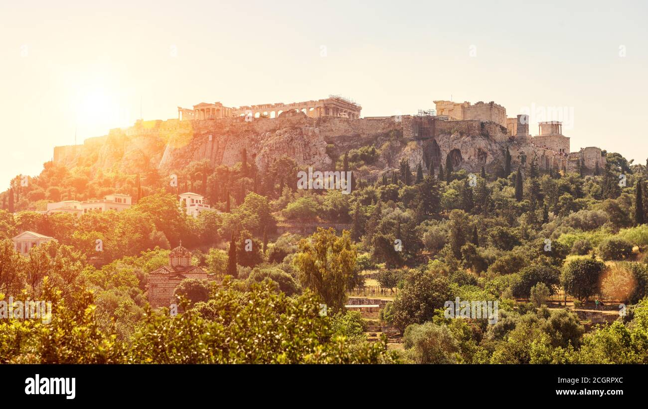 Acropolis at sunset, Athens, Greece. Urban landscape of Athens, scenic sunny view from old Agora. Scenery of famous Ancient Greek ruins in Athens city Stock Photo