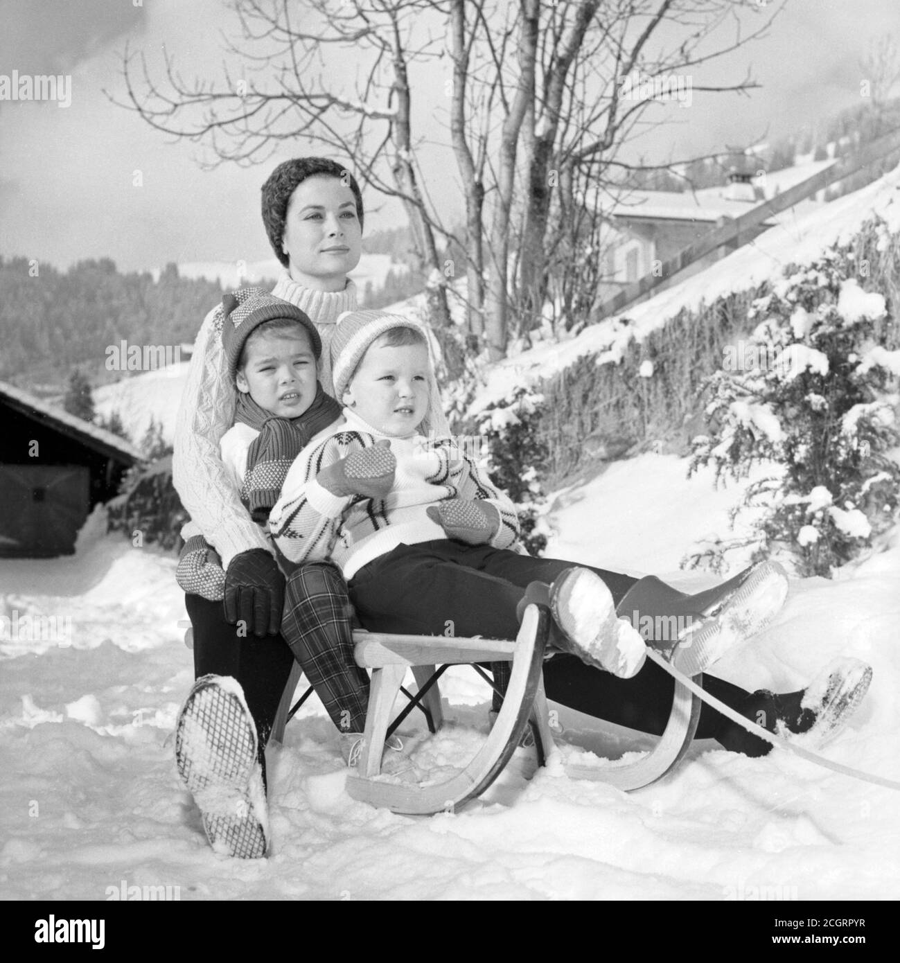Princess Grace of Monaco (Grace Kelly) on a sled with her son Caroline and Albert (Gstaad, 1962) Stock Photo