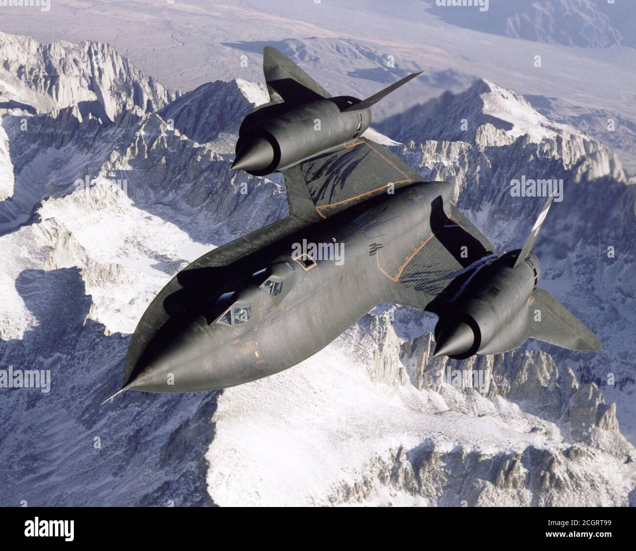Dryden's SR-71B, NASA 831, slices across the snowy southern Sierra Nevada Mountains of California after being refueled by an Air Force Flight Test Center tanker during a recent flight. The Mach 3 aircraft are being flown by the Dryden Flight Research Center, Edwards, California as testbeds for high-speed, high-altitude aeronautical research. Capable of flying more than 2200 mph and at altitudes of over 85,000 feet, they are excellent platforms for research and experiments in aerodynamics, propulsion, structures, thermal protection materials, atmospheric studies, and sonic boom characterization Stock Photo