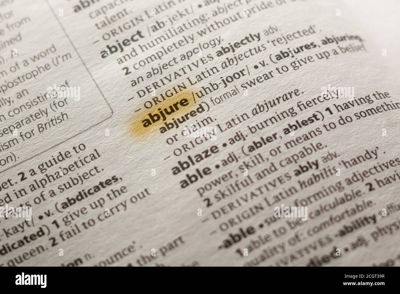 The word or phrase Abjure in a dictionary highlighted with marker. Stock Photo
