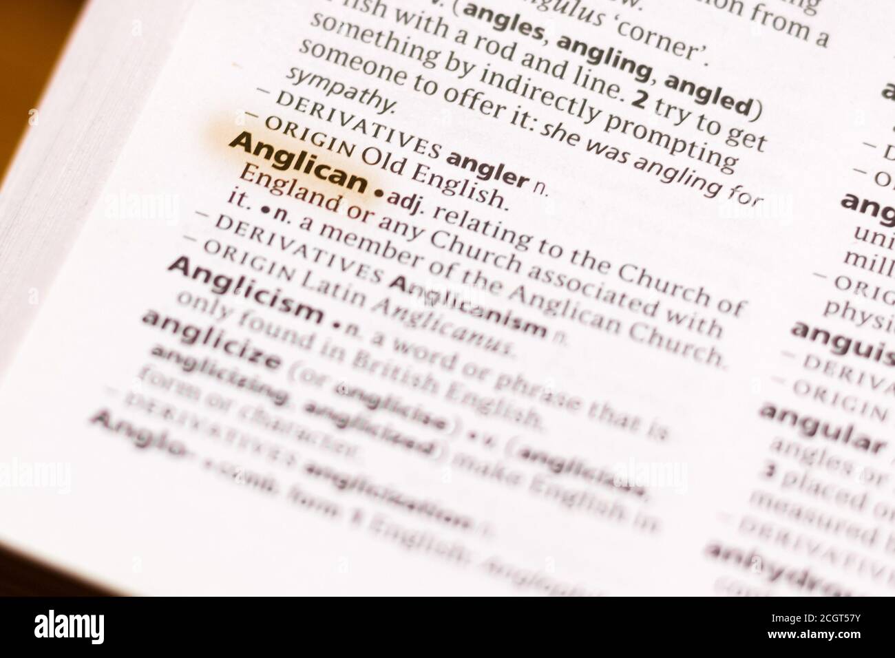 The word or phrase Anglican in a dictionary highlighted with marker ...