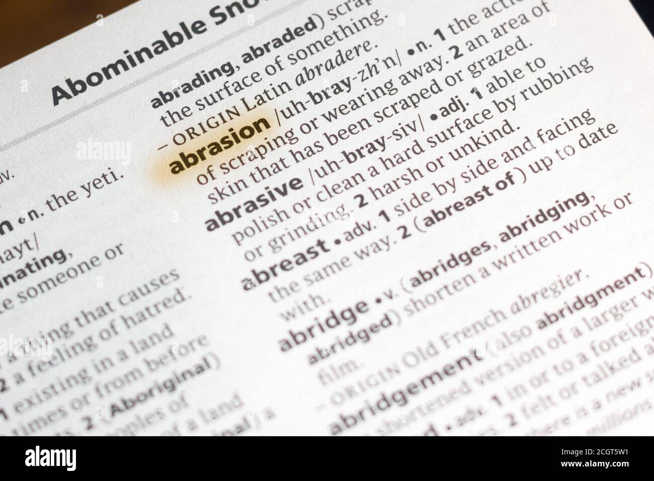 The word or phrase Abrasion in a dictionary highlighted with marker