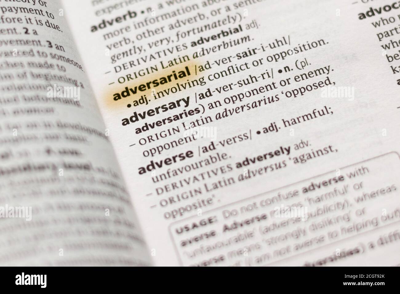 The word or phrase Adversarial in a dictionary highlighted with marker. Stock Photo