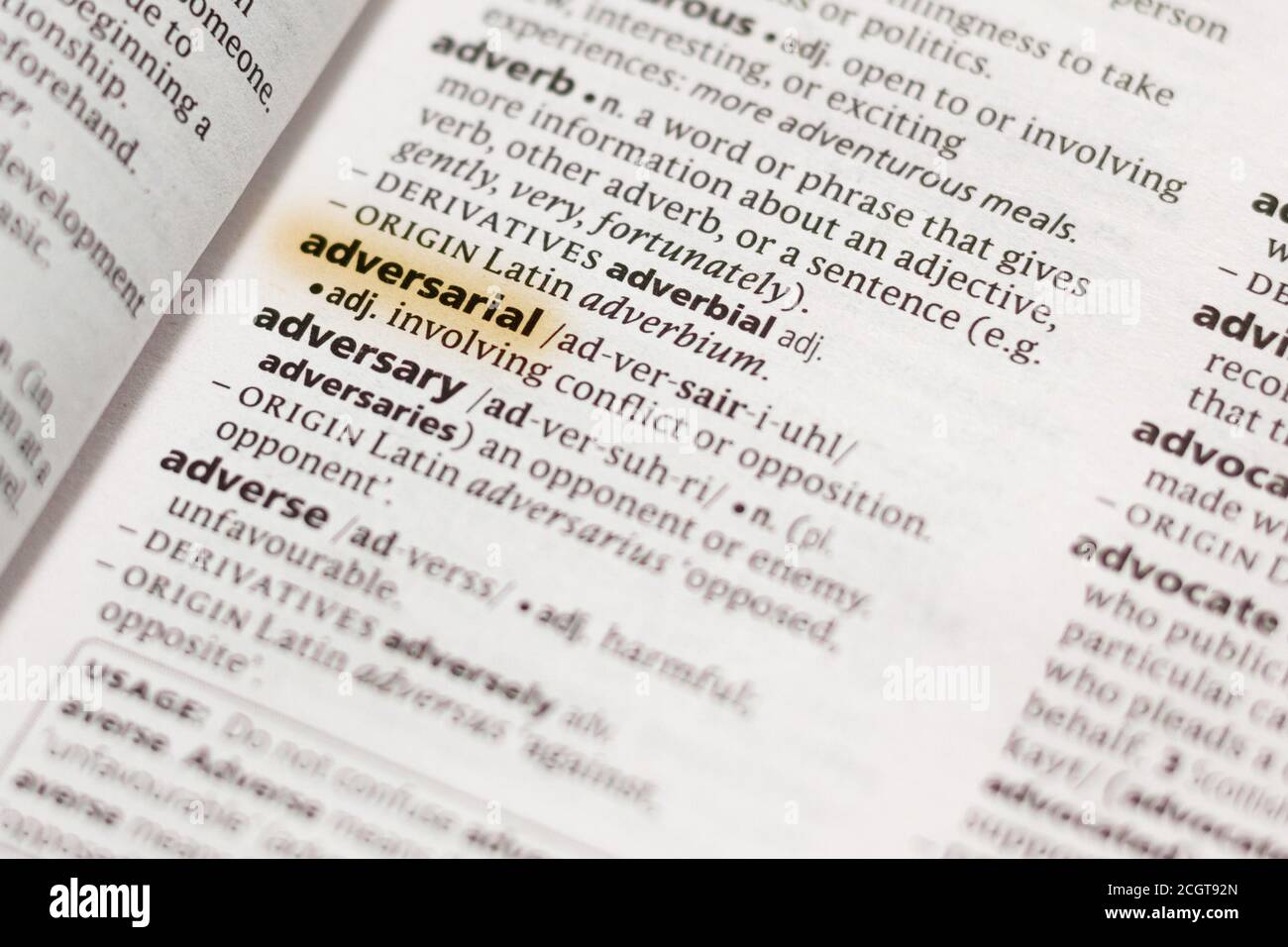 The word or phrase Adversarial in a dictionary highlighted with marker. Stock Photo
