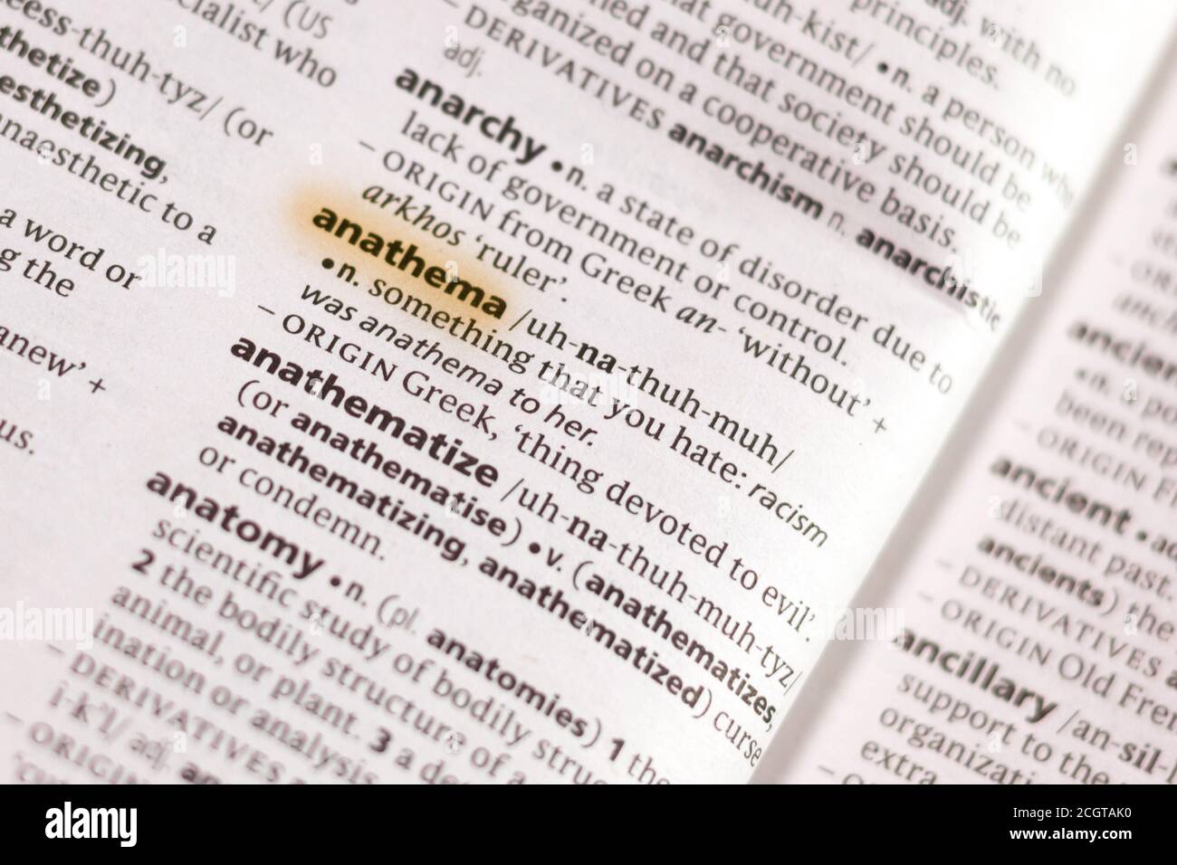 The word or phrase Anathema in a dictionary highlighted with marker