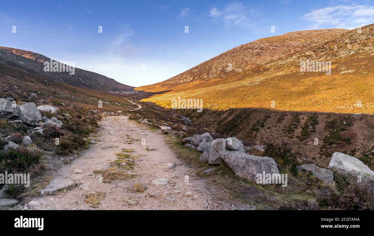 Hiking on winding trail in the valley between Slieve Donard and Rocky