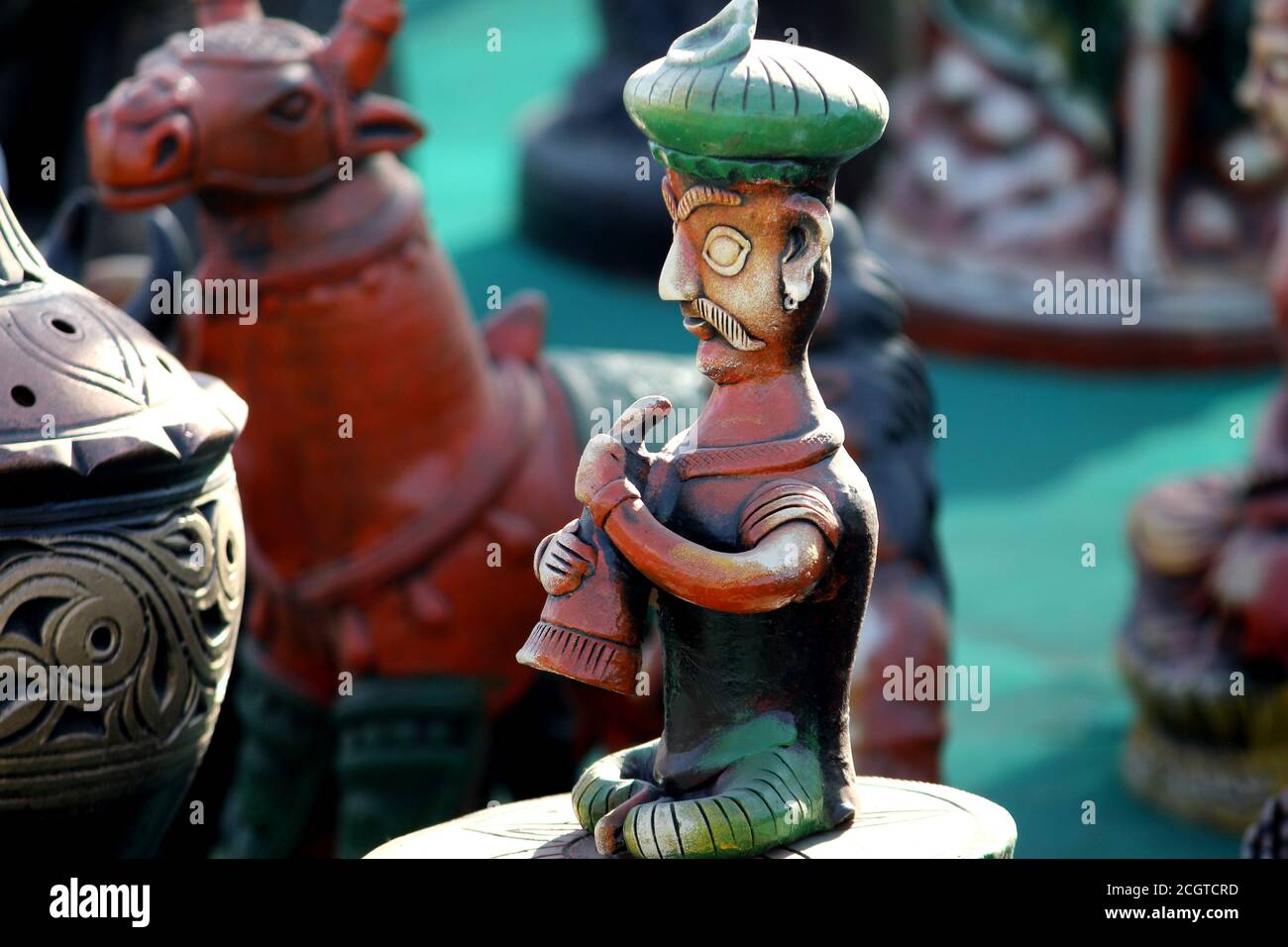 traditional turban man clay sculpture, handcraft Indian musician vintage statue in market Stock