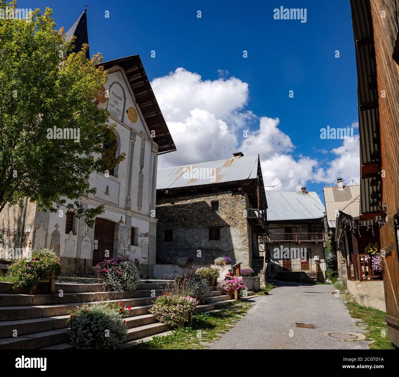 Church and old buildings at Puy-Saint-Vincent, ski resort, in summer, Vanoise National Park, Ecrins, France Stock Photo