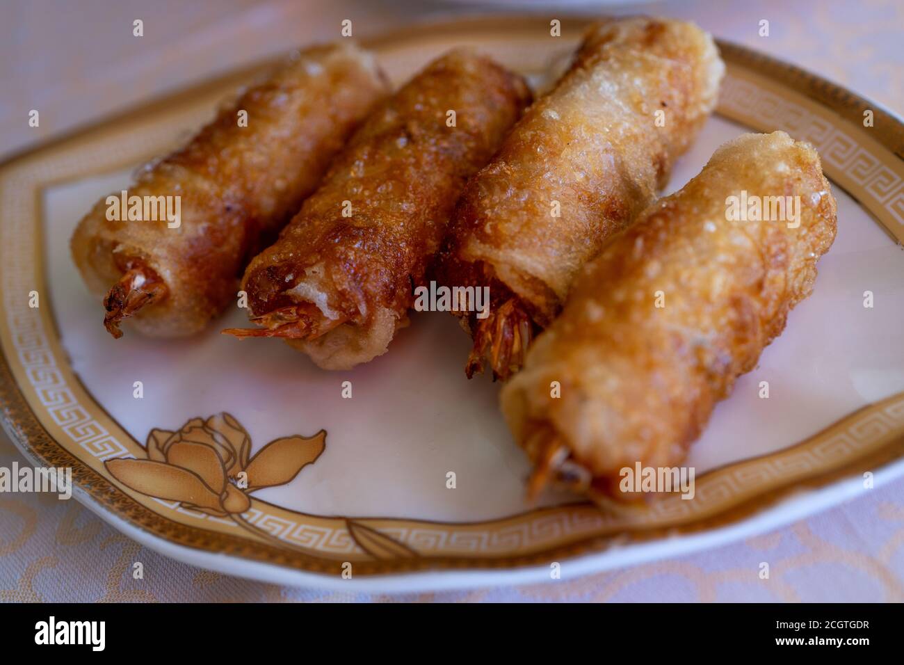 Fried spring rolls on light plate. Delicious Thai spring rolls.  Stock Photo