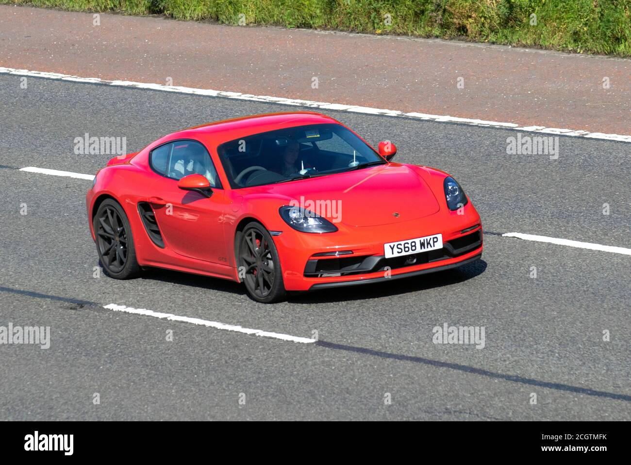 2018 red Porsche 718 Cayman GTS S-A; Vehicular traffic moving vehicles, cars driving vehicle on UK roads, motors, motoring on the M6 motorway highway network. Stock Photo