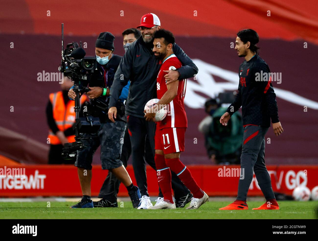 Liverpool's Mohamed Salah (right) embraces manager Jurgen Klopp with the matchball after scoring a hat-trick in the Premier League match at Anfield, Liverpool. Stock Photo