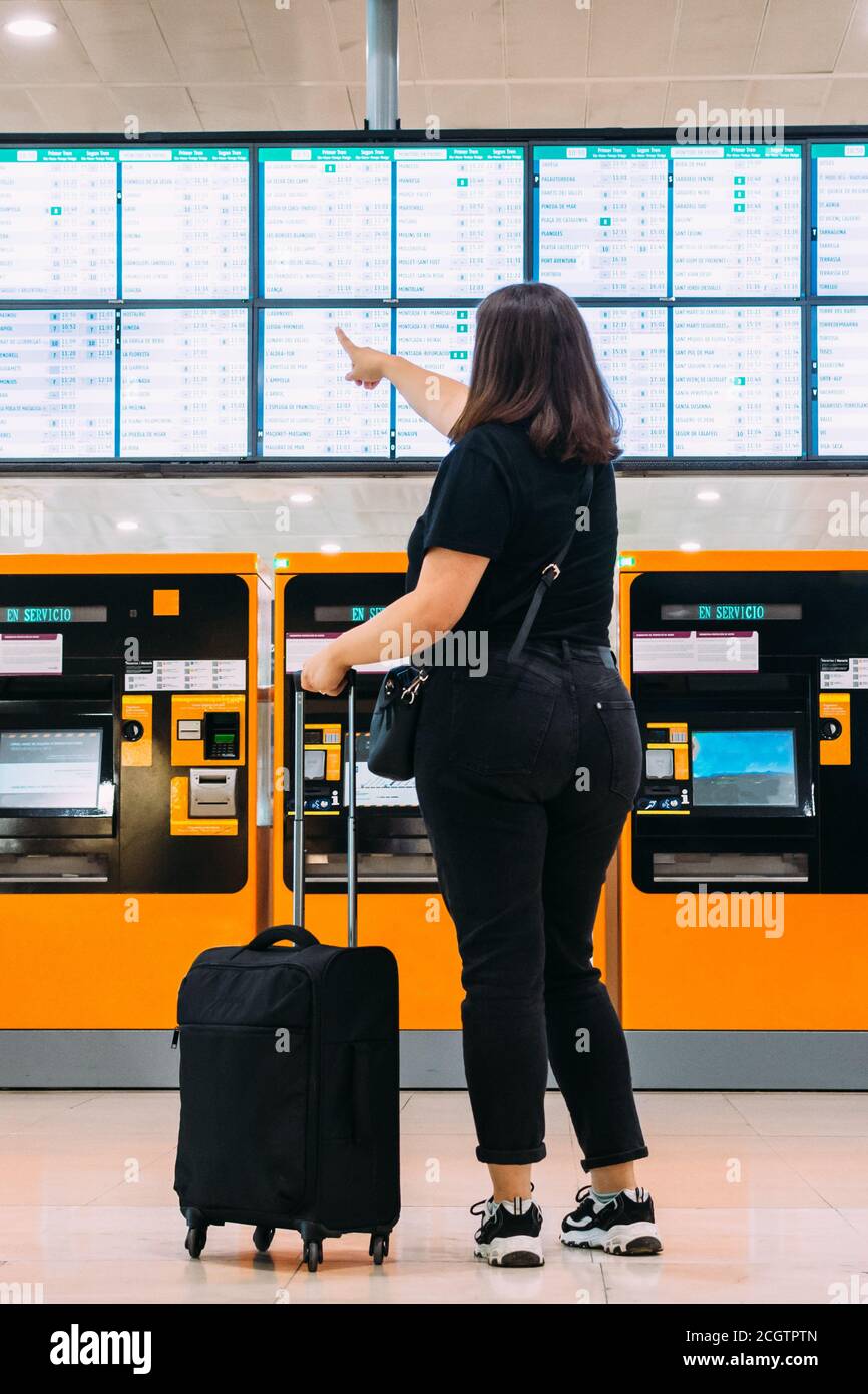 woman looking at train departure times Stock Photo