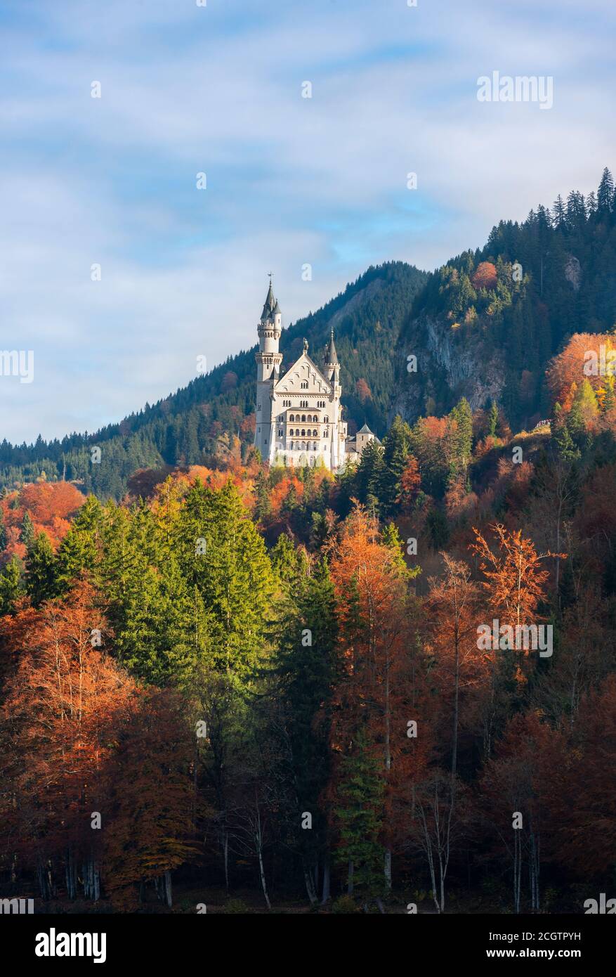 Autumn scenery with colorful trees and the Bavarian Alps mountains, on a sunny day, in Fussen, Germany. Fall landscape with castle and forest. Stock Photo