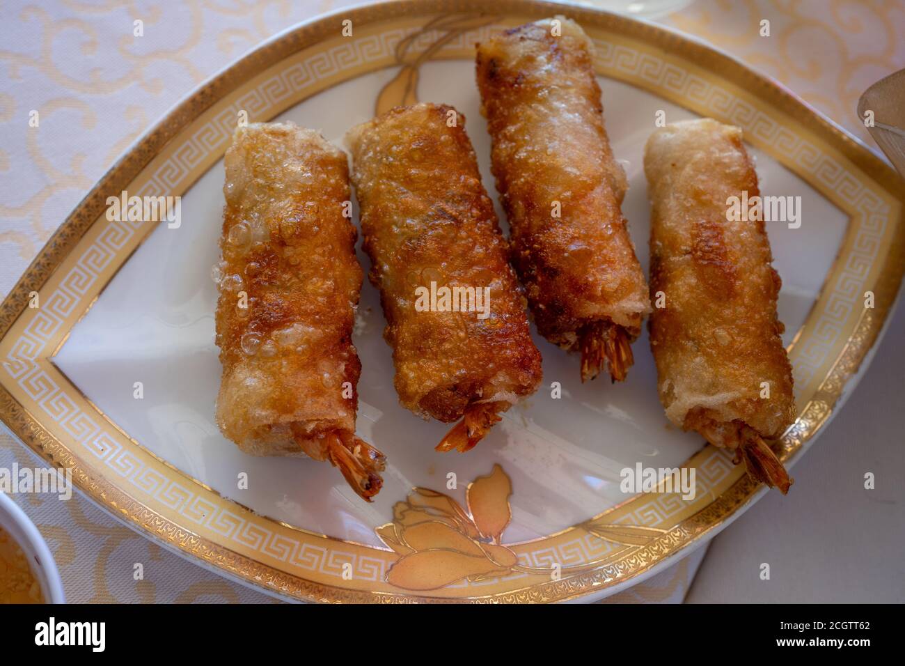 Fried spring rolls on light plate. Delicious Thai spring rolls.  Stock Photo