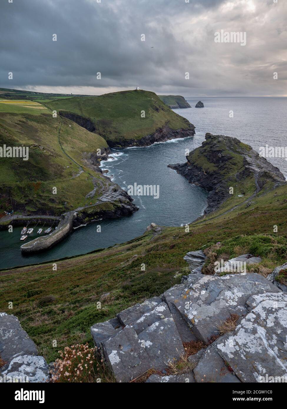 Looking down on the harbour and out to sea at Boscastle in Cornwall at sunset Stock Photo