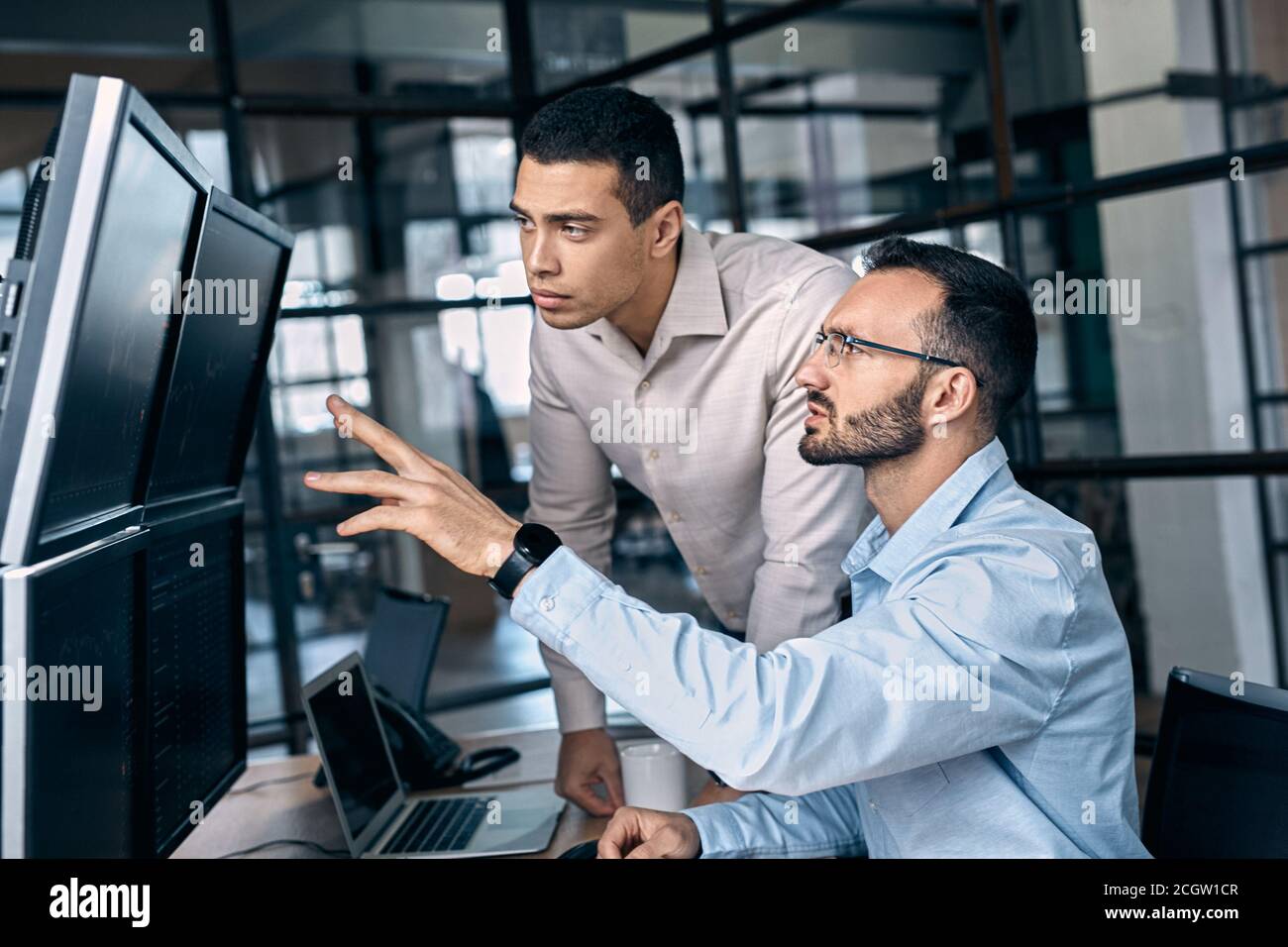 Two traders analyzing stat and dynamic on forex charts Stock Photo