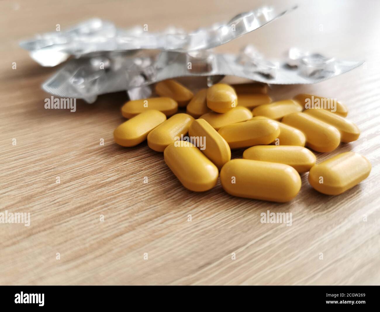 20 pills, two packs of tablets dietary supplements on wooden table. Stock Photo