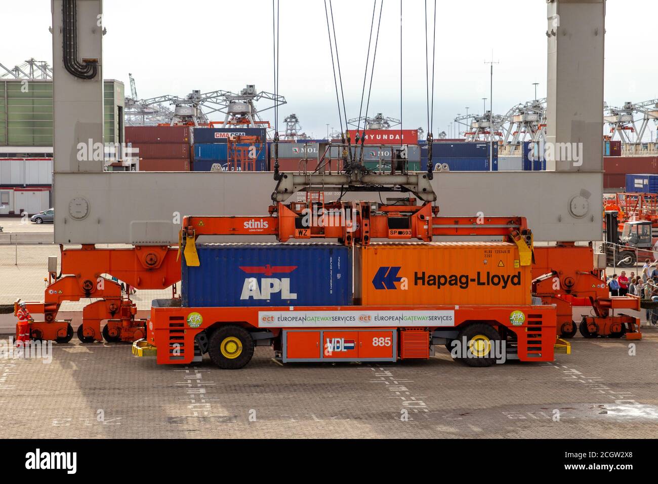 Gantry crane operator placing shipping containers on a automated transport vehicle in the Port of Rotterdam, The Netherlands, September 8, 2013. Stock Photo