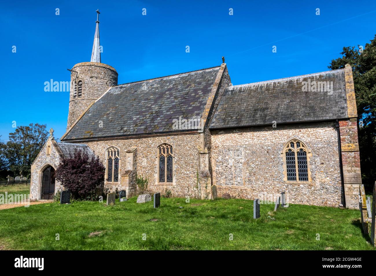 The round towered flint church of St Mary at Titchwell on the North Norfolk coast. Stock Photo