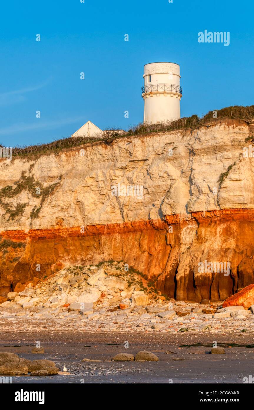 Evening sunlight on the famous striped cliffs and the lighthouse on the