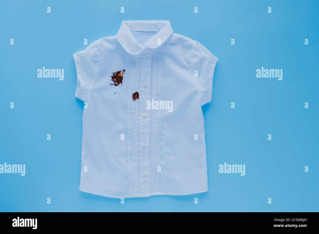Dirty white shirt daily life stain concept. isolated.on a blue background.top view Stock Photo