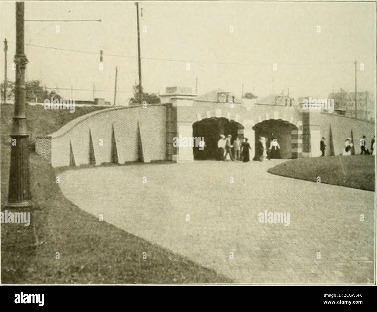 . The street railway review . BRICK P.WED HIGHWAY CROSSING. ing walls is shown herewith. This tunnel extends from the portalnear the music pavilion, under the tracks of the Doylestown andIlatboro lines, the Germantown turnpike and the several storagetracks of the Glenside and York Road lines. The walls of thetuimel are of concrete, the roof is of reinforced concrete and thedoor is paved with red brick. From the portal to the farther endof the tunnel a fence of steel rods divides the passageway intohalves thus separating the incoming passengers from those goingto the loading platforms. The seve Stock Photo