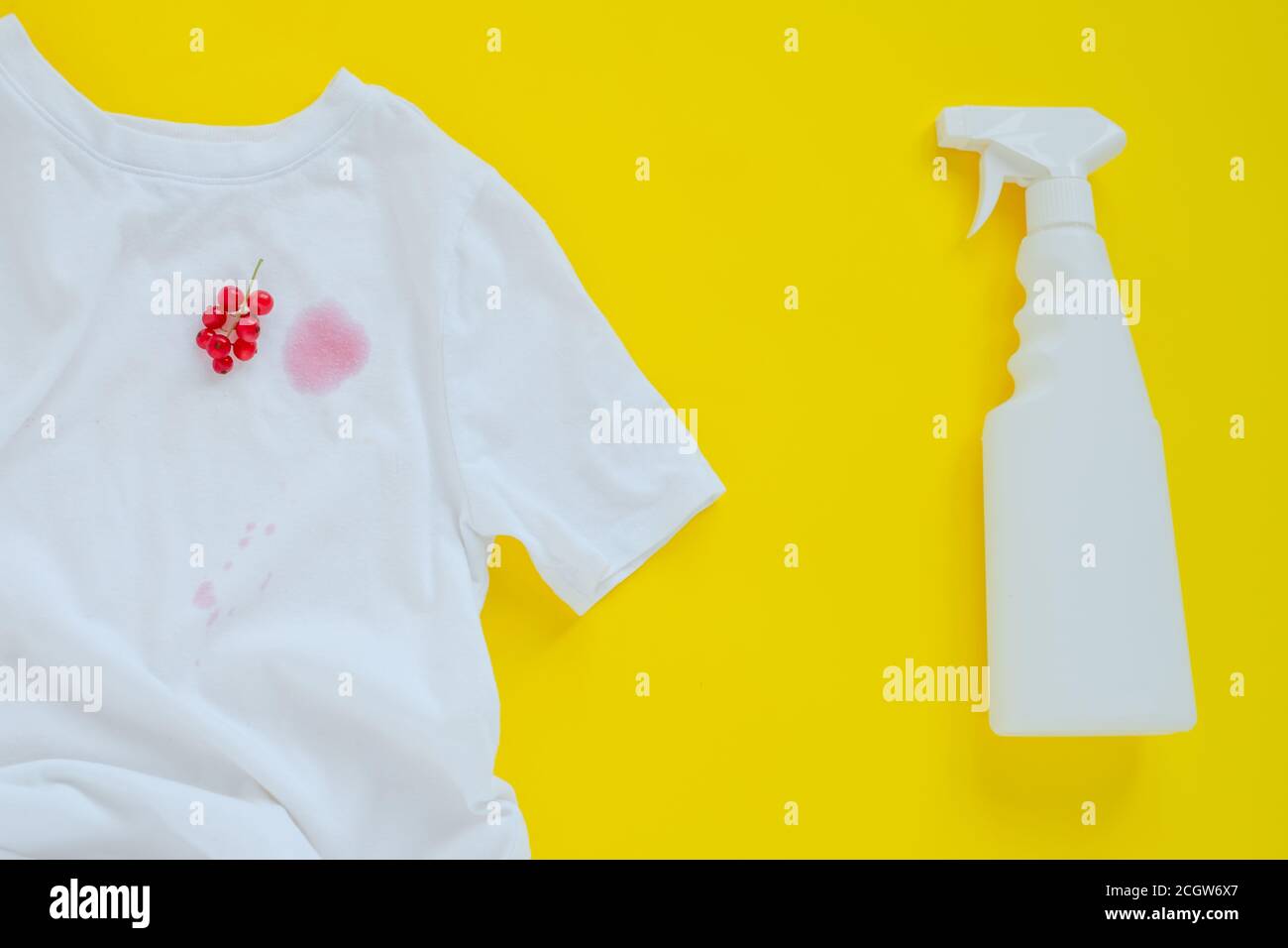 red currant stain on white clothes. isolated on yellow background.top view Stock Photo