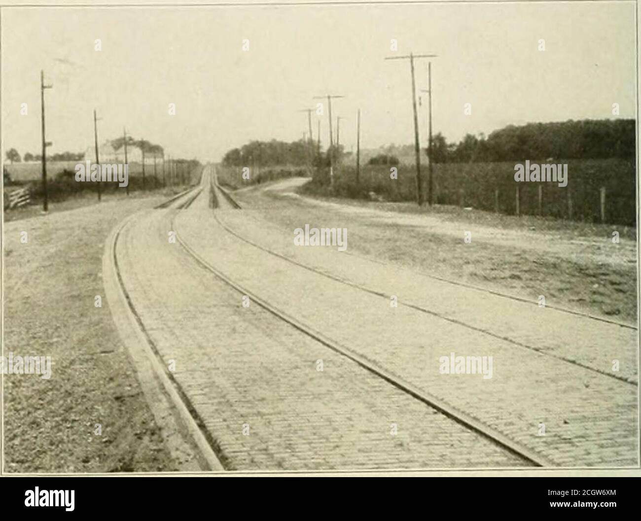 . The street railway review . property with its top oil a level slightly above the unloading plat-form. These four similarly built platforms, two of which are usedfor loading and two for unloading, arc so enclosed by the fencesthat entrance may not be gained to them except by means of a largetunnel and inclines from the tunnel to the platform level. Thistunnel has its portal inside the limits of the park proper and at theintersection of several broad avenues near the music pavilion. Th(?p irtal of an ornamental design with long ornamental hriek retain-. BRICK P.WED HIGHWAY CROSSING. ing walls Stock Photo