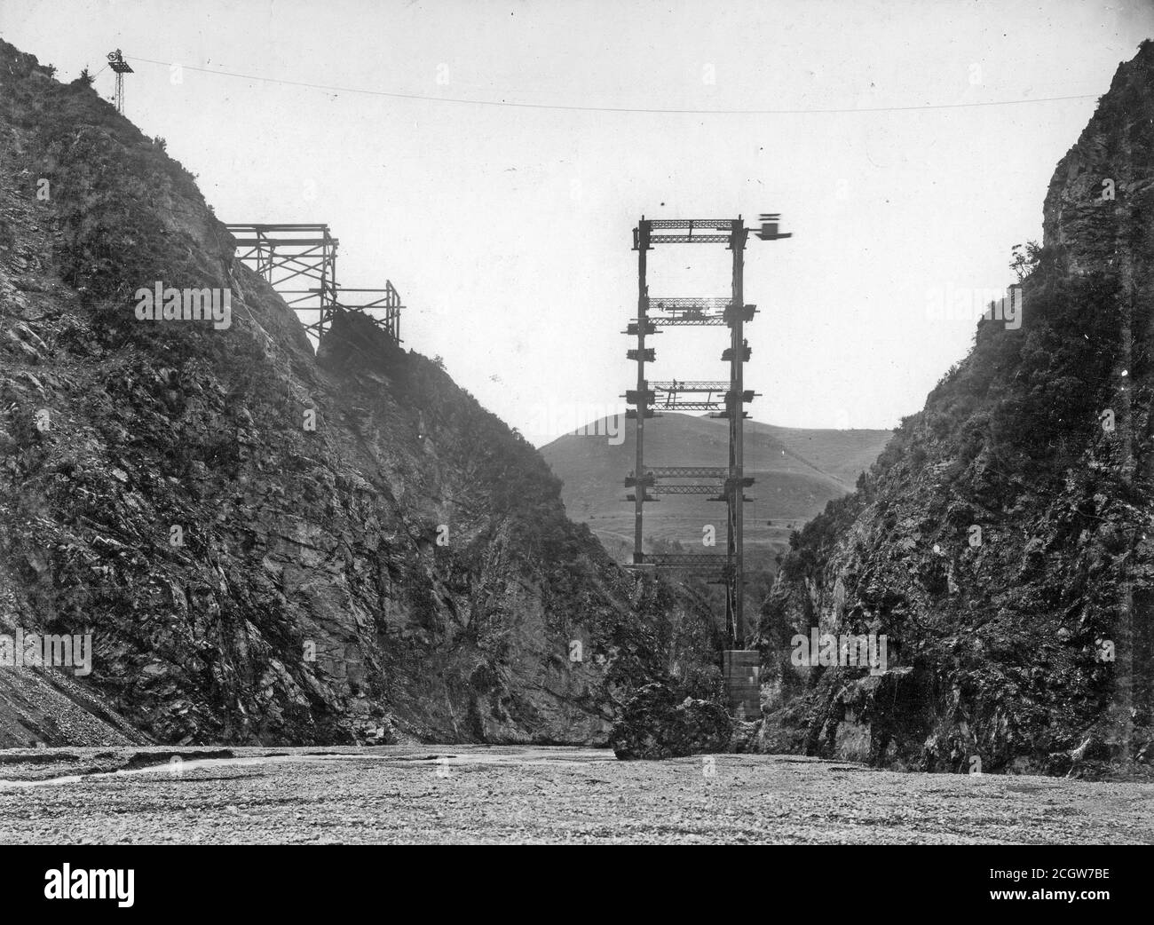 Work continues on the railway viaduct across Staircase Gully on the Midland Line, South Island, New Zealand, in about 1905. The viaduct from point to point is 180 feet across and consists of a 60 foot abutment, two space of 192 feet each and a 36 feet piece. The pier is made of iron 220 feet in height on a strong concrete foundation. From the Logie family collection. Stock Photo