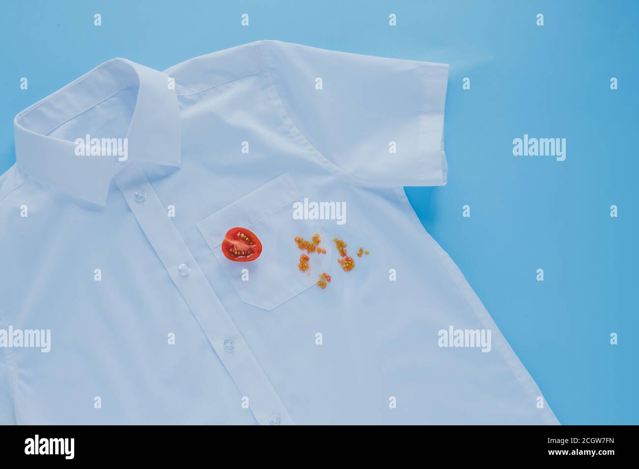 stains from fresh tomatoes on a white shirt. Stock Photo