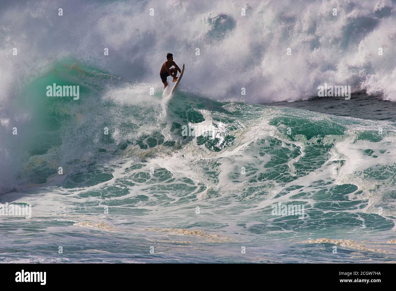 Unrecognizable surfer being spit out by a large north shore wave on Oahu. Stock Photo