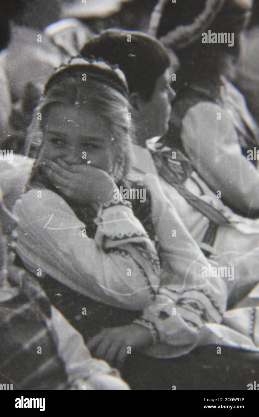 Fine 70s vintage black and white photography of a girl that's trying hard not to laugh out loud. Stock Photo