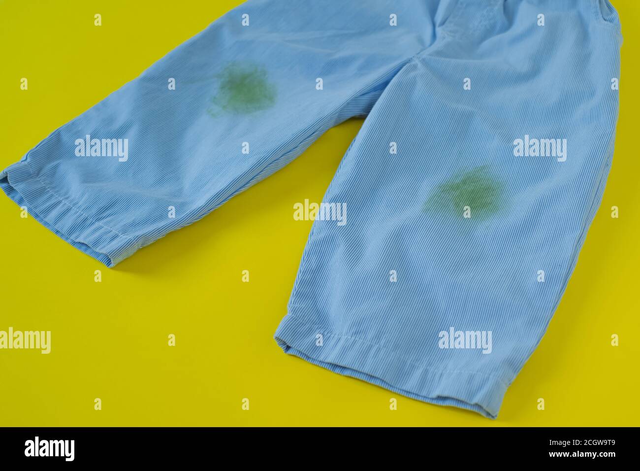 grass stains on pants.isolated on yellow background Stock Photo