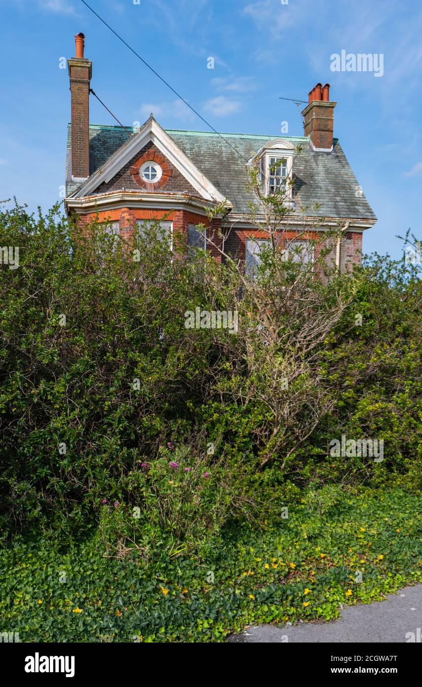 Grade II listed remains with boarded up windows of Neo-Caroline style outhouse on grounds of Rustington Convalescent Home in West Sussex, England, UK. Stock Photo