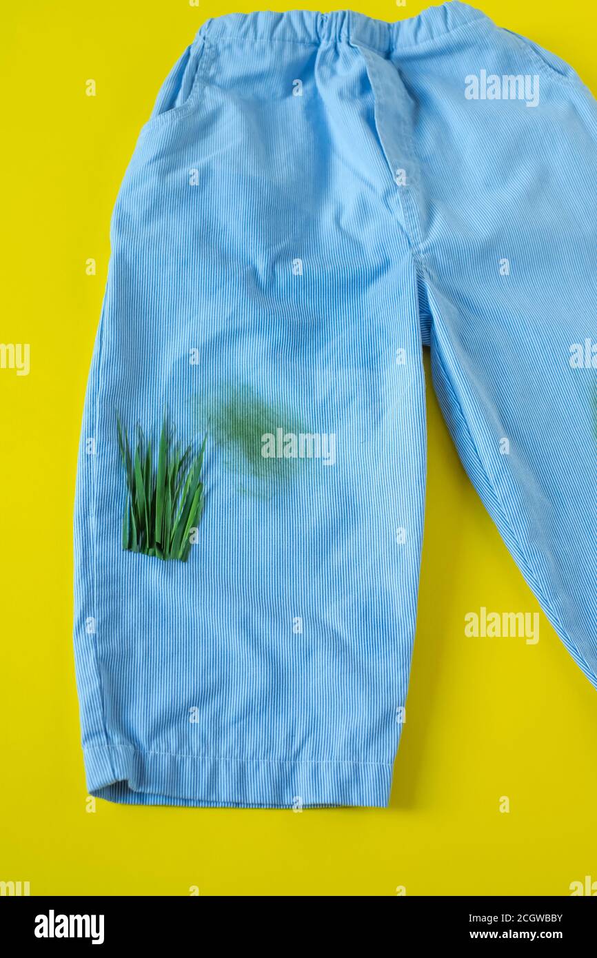 grass stains on pants.isolated on yellow background Stock Photo