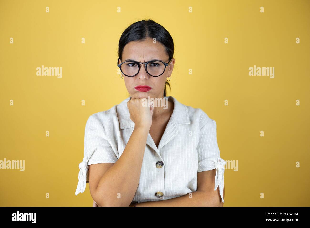 Beautiful woman over yellow background thinking looking tired and bored ...