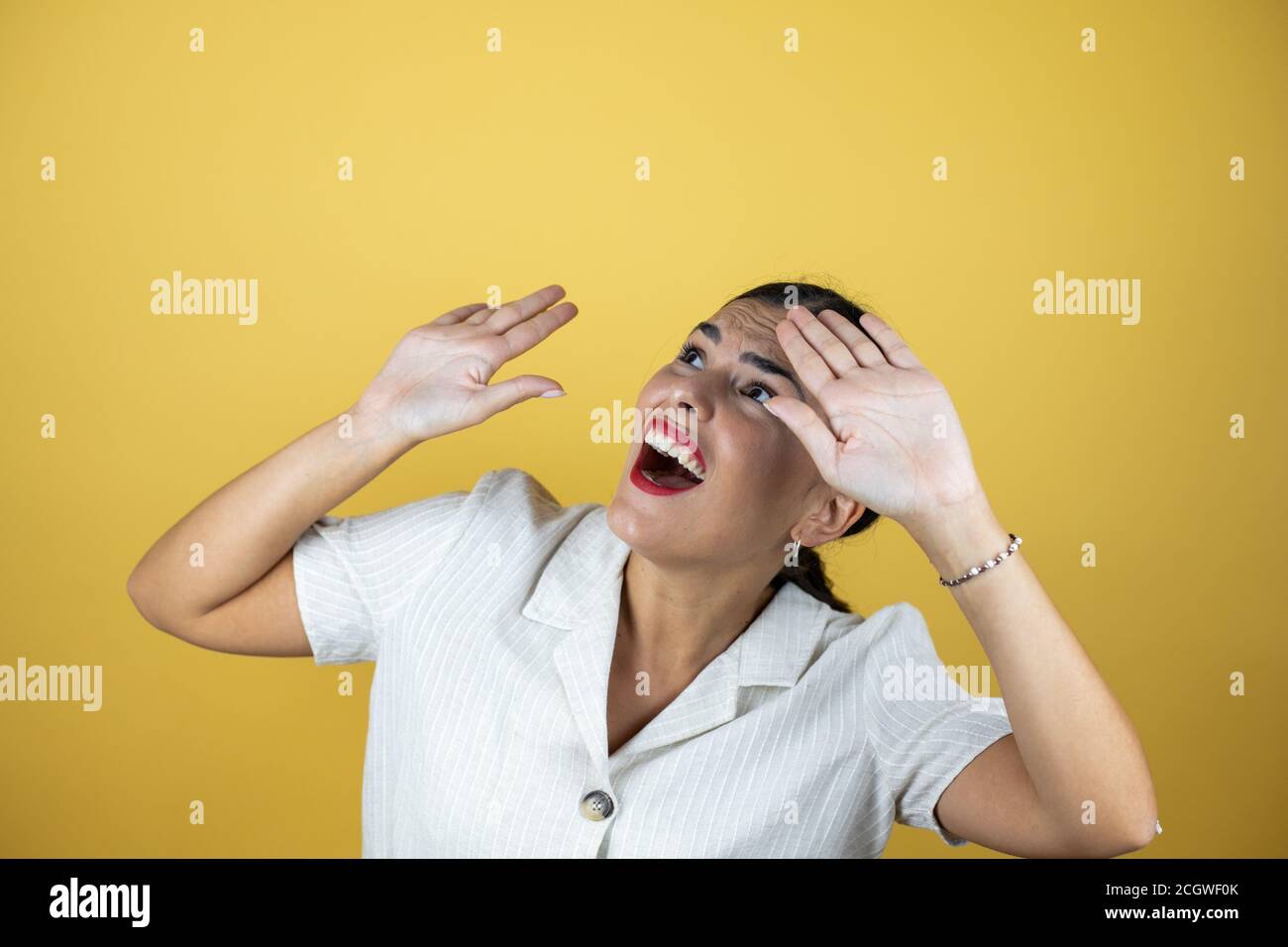 Beautiful woman over yellow background with a successful expression Stock Photo