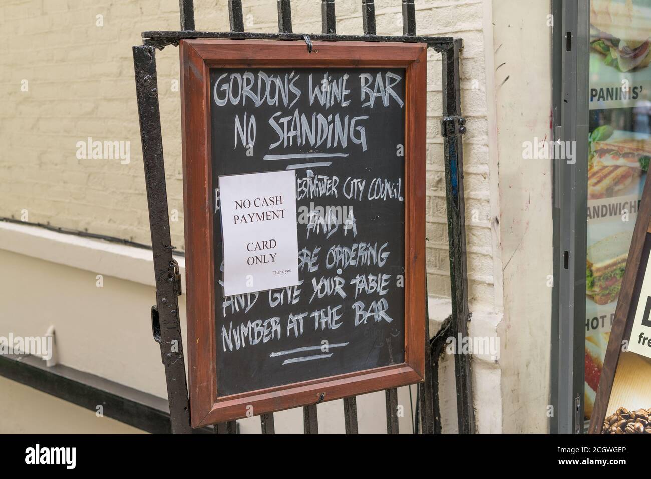 A sign outside Gordon's Wine Bar saying that the don't accept cash. London Stock Photo